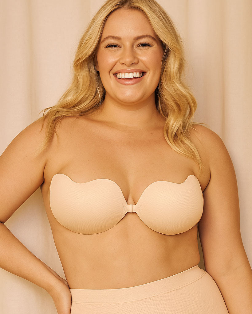 Woman wearing a beige strapless bra against a beige background